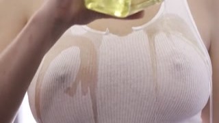 Blonde gets oiled up and titfucks a guy